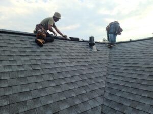 Roof technician examining shingle wear in Brentwood, MO