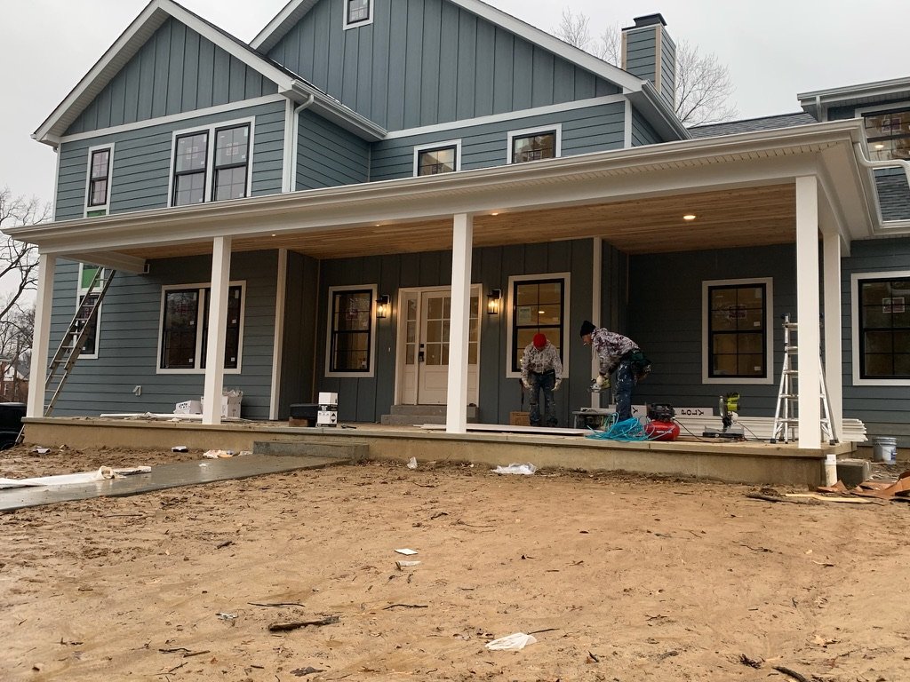 LP SmartSide lap siding blue new construction front porch crew installing in St. Louis MO
