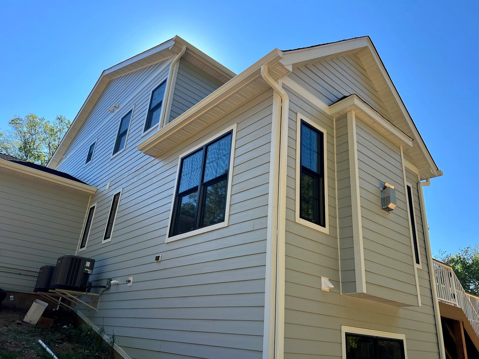 Cream James Hardie siding new construction with black windows