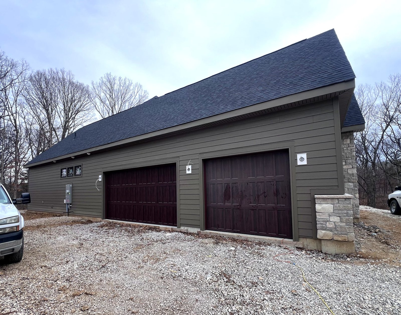James Hardie lap siding on garage with stone accent columns installed by Meridian Roofing