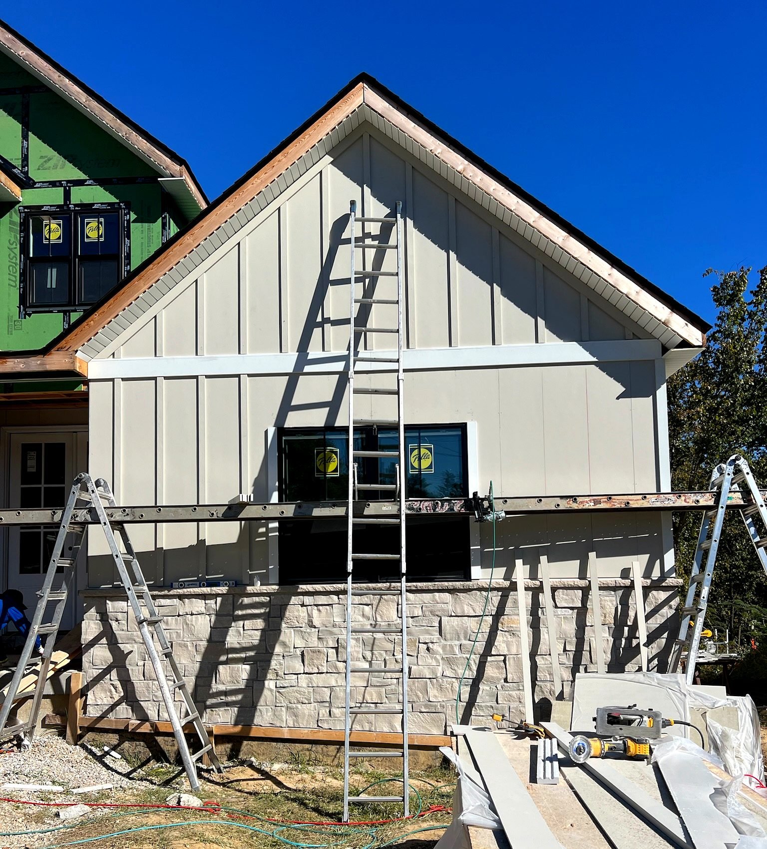 White James Hardie board and batten siding with stone accent