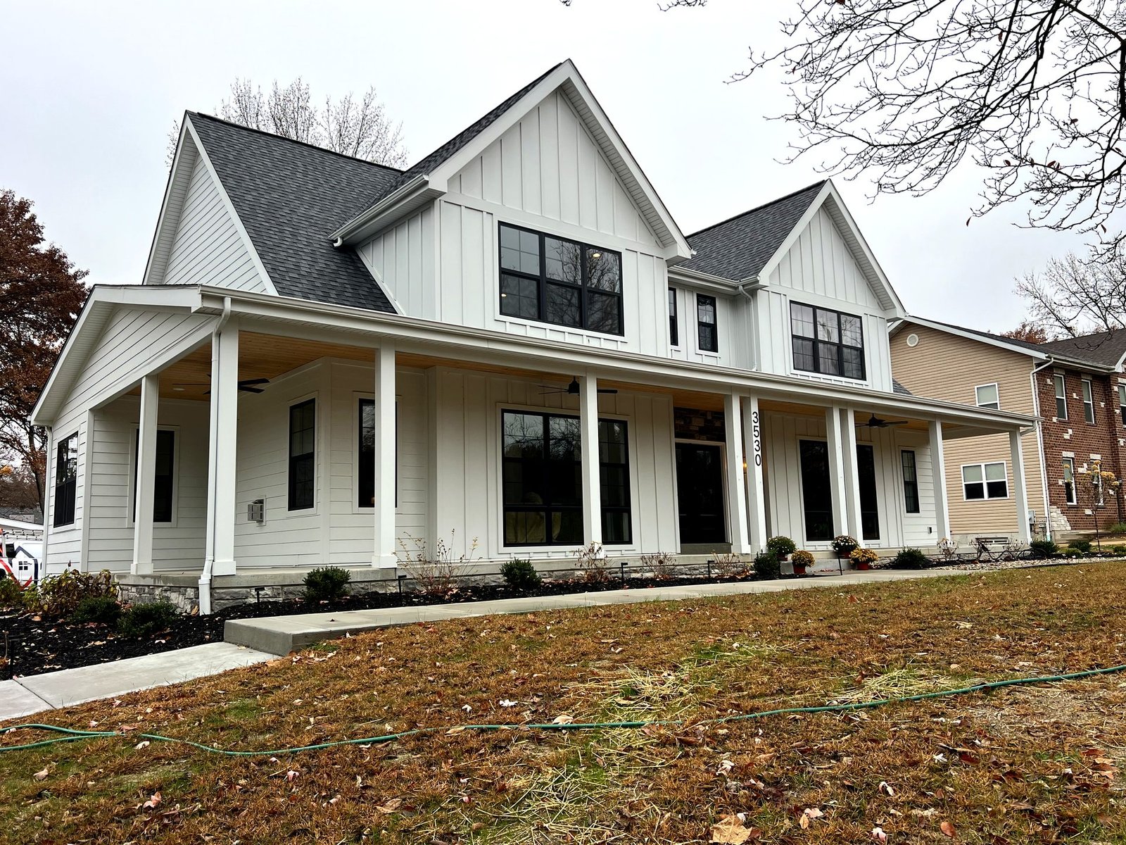 White James Hardie farmhouse siding with board and batten and wraparound porch