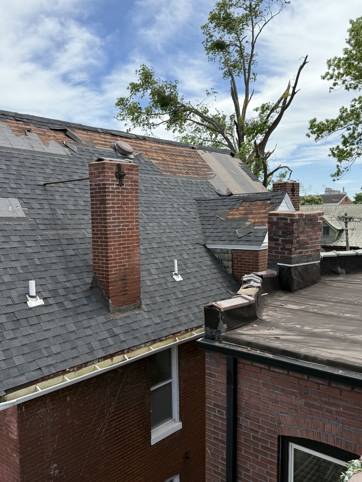 Chimney flashing and shingle wear documented during roof inspection in St. Louis
