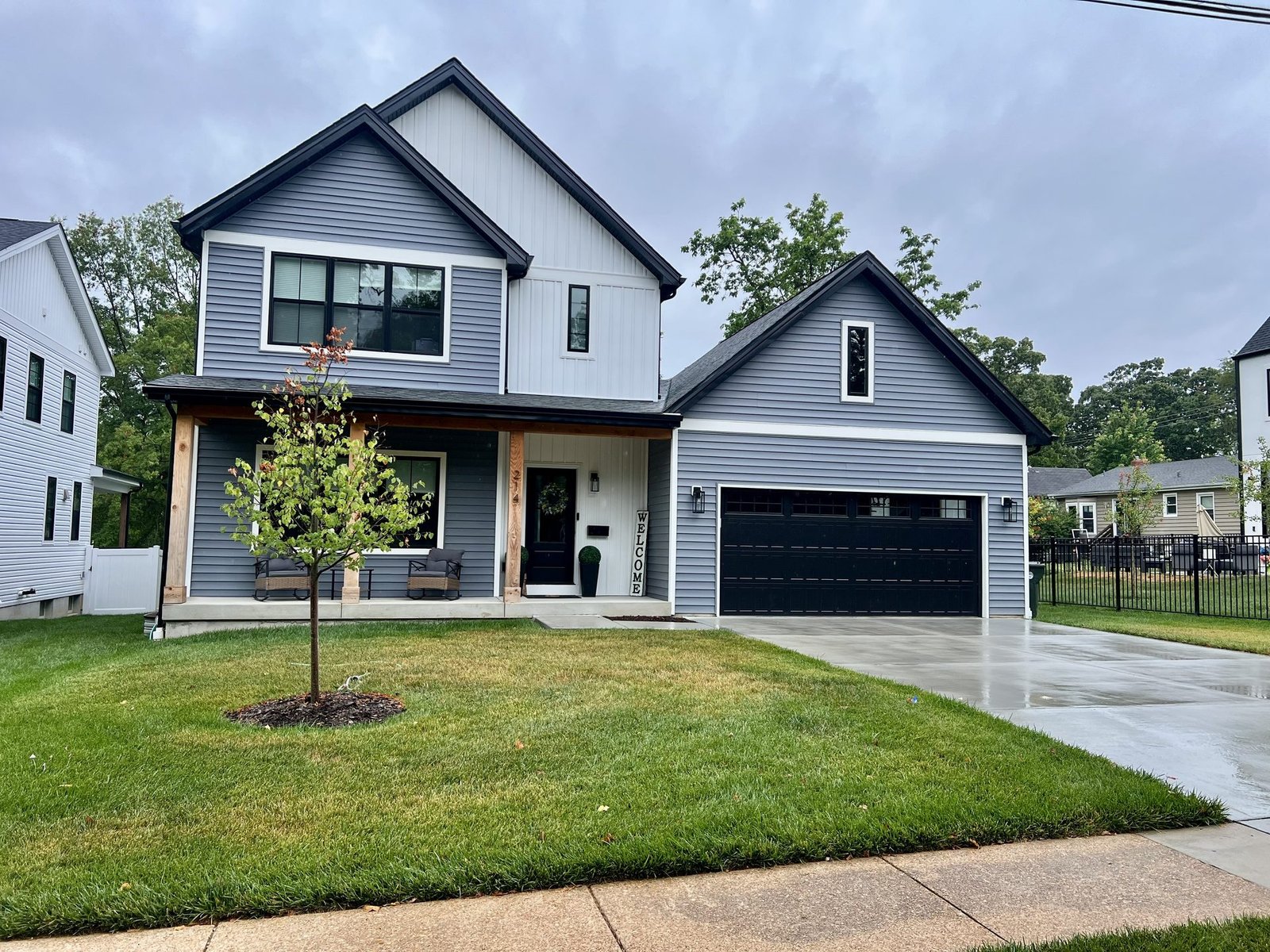 Gray and white two-tone vinyl siding installation on modern farmhouse in St. Louis by Meridian Roofing