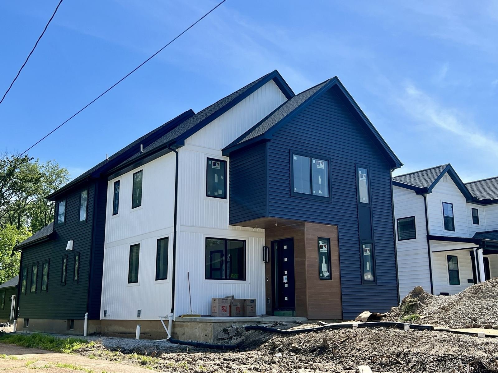 Navy and white two-tone vinyl siding new construction installation in St. Louis by Meridian Roofing