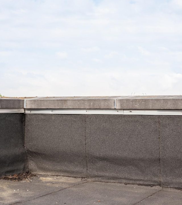 Contractor inspecting rooftop by commercial roofing near me in St. Charles, MO
