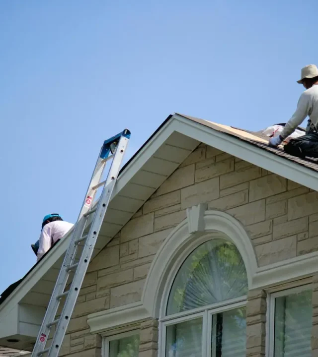 Crew laying shingles by roofing company in St. Charles, MO