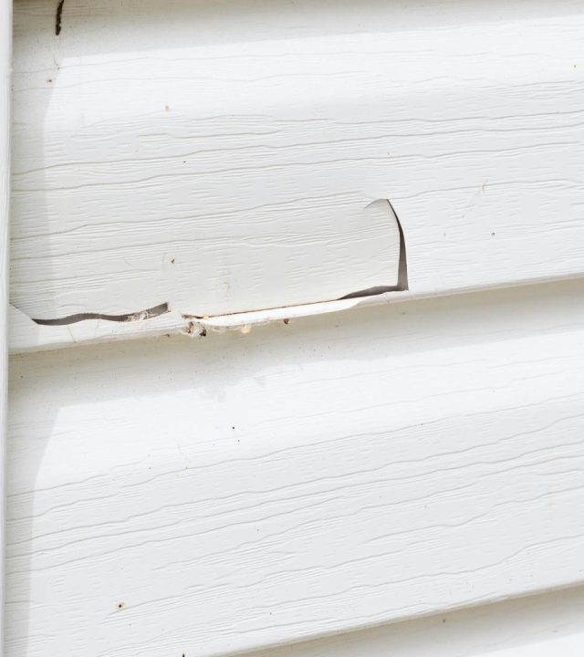 Crew patching siding damage by siding repair near me in O’Fallon, MO