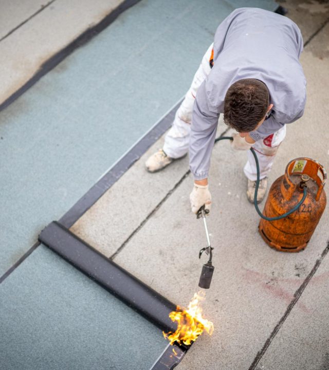 Crews performing maintenance by commercial roofing near me in O'Fallon, MO