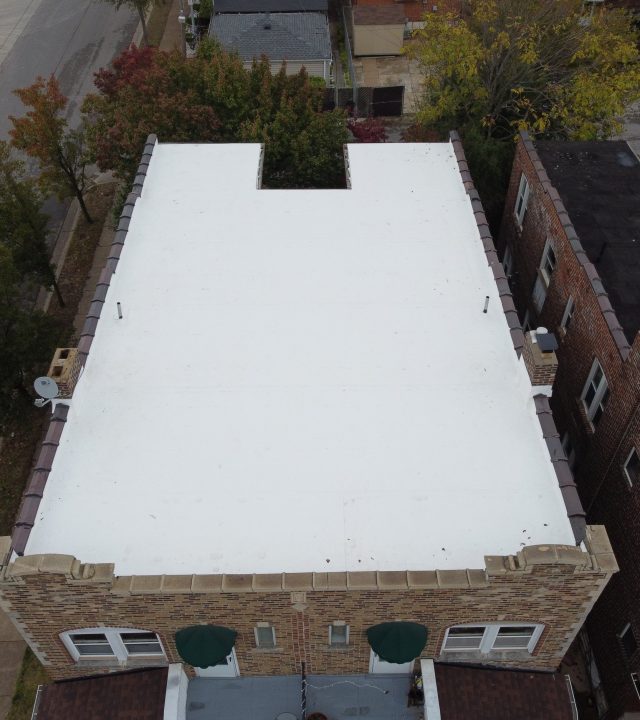 Meridian Roofing and Renovation team installing a TPO flat roof in St. Louis, MO.