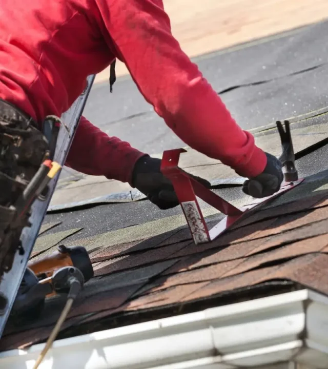 Expert crew replacing shingles by roofing company in Brentwood, MO