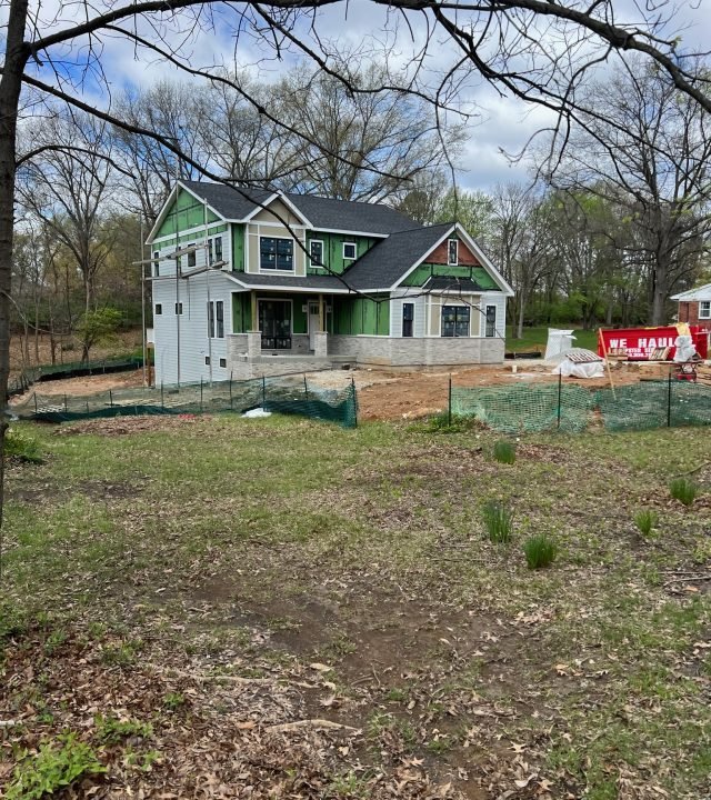 Meridian Roofing and Renovation team repairing damaged siding on a home in St. Louis, MO.