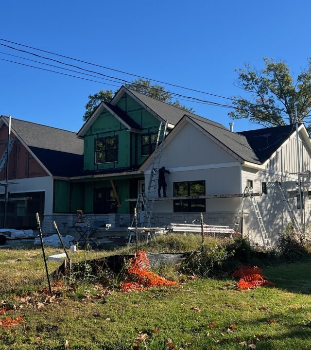 Meridian Roofing and Renovation team repairing damaged siding on a home in St. Louis, MO.