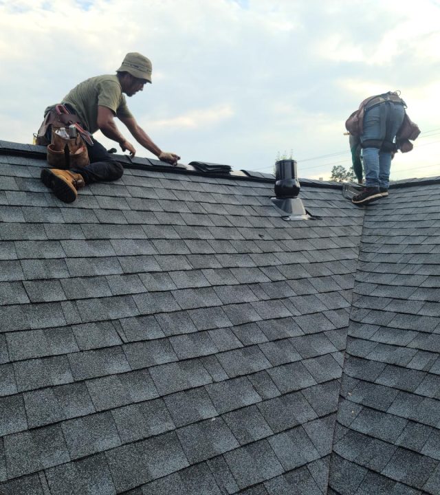 Roof technician examining shingle wear in Brentwood, MO