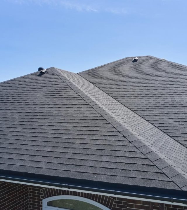 Technician checking shingles during roof inspection in Creve Coeur, MO Technician checking shingles during roof inspection in Creve Coeur, MO
