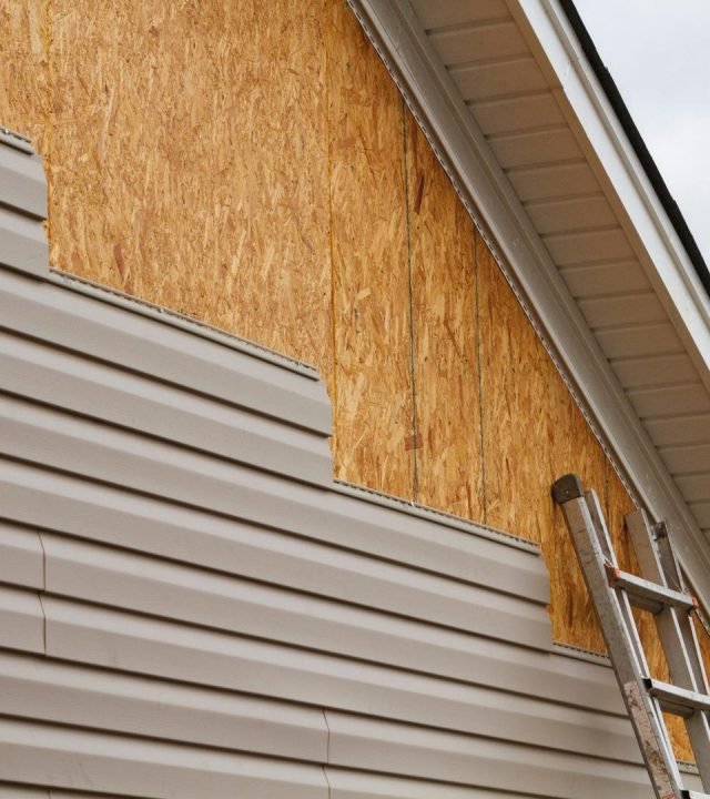 Technician replacing boards during siding repair near me in Kirkwood, MO Technician replacing boards during siding repair near me in Kirkwood, MO