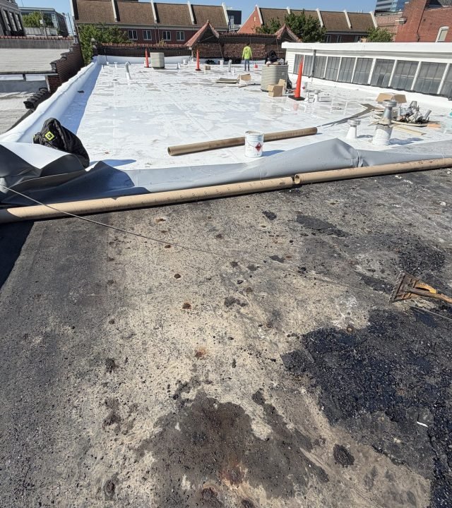Commercial TPO flat roof membrane installation in progress on a St. Louis, MO building by Meridian Roofing and Renovation