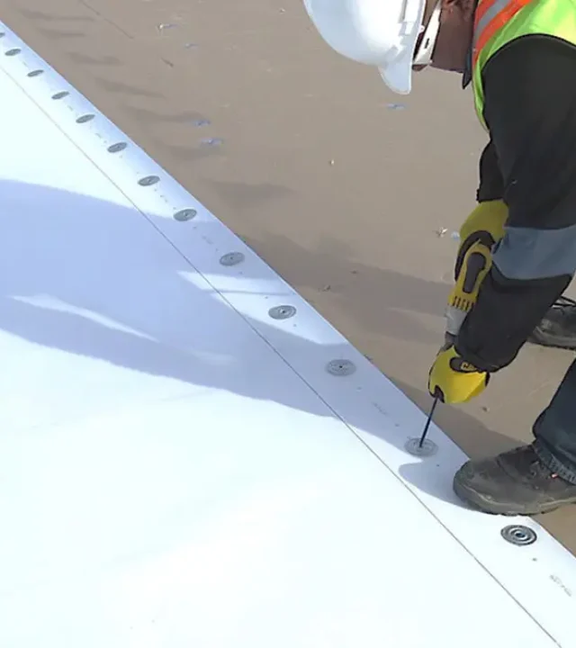 New white TPO membrane being installed on a commercial roof in St. Louis by Meridian Roofing